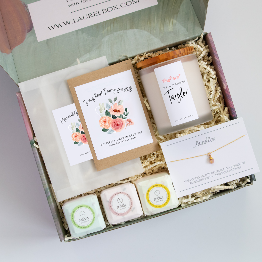 photo of a gift box containing seed packet, a memorial candle, shower steamers and a raw cut gemstone necklace
