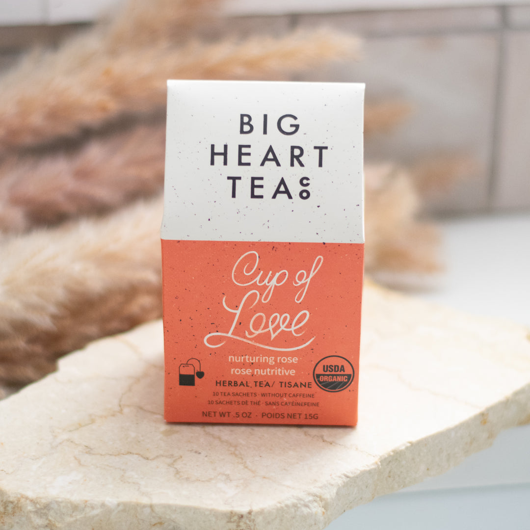 A Big Heart Tea Company Cup of Love bag of tea on a granite surface.