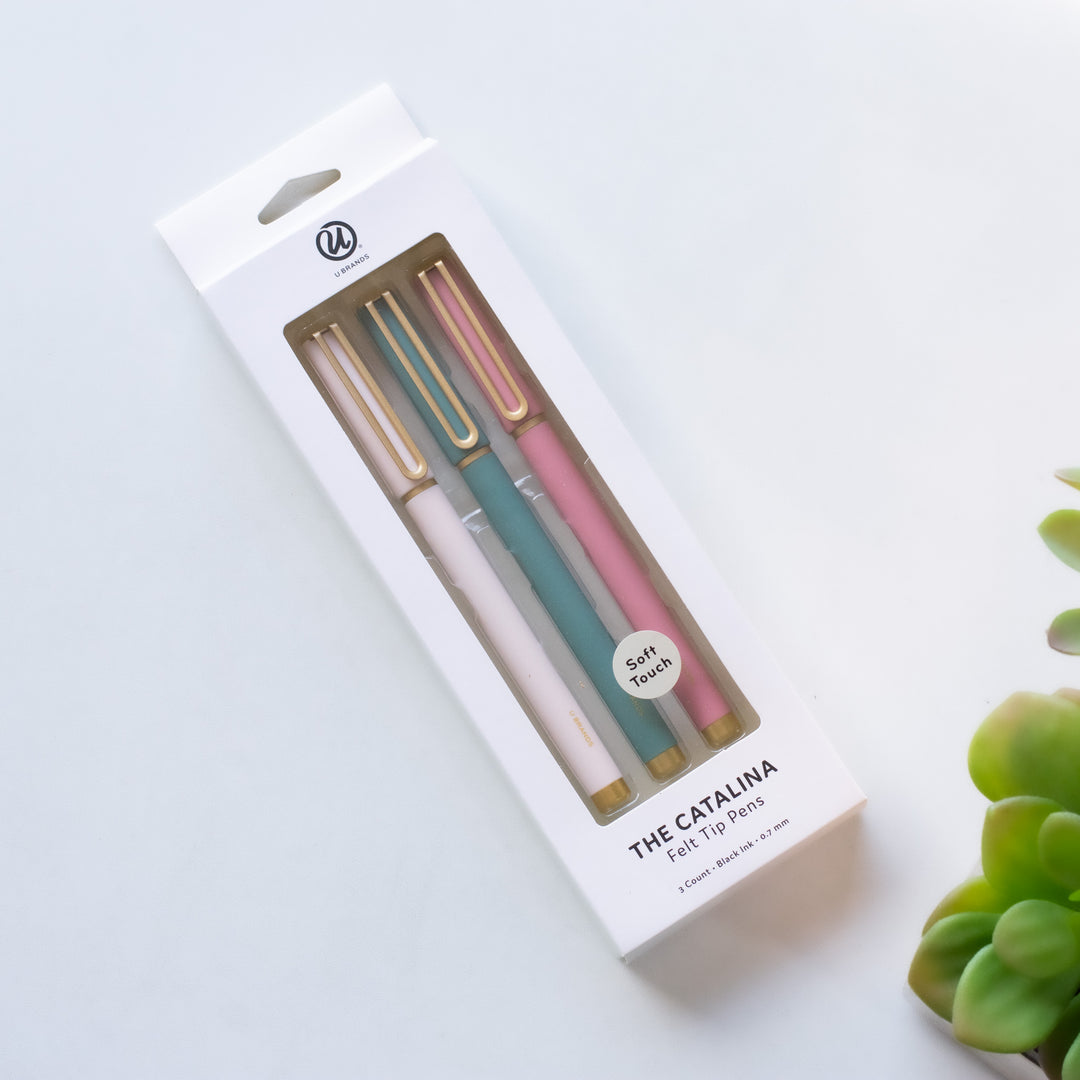 photo of a package of 3 pens one white, one dark green and one pink