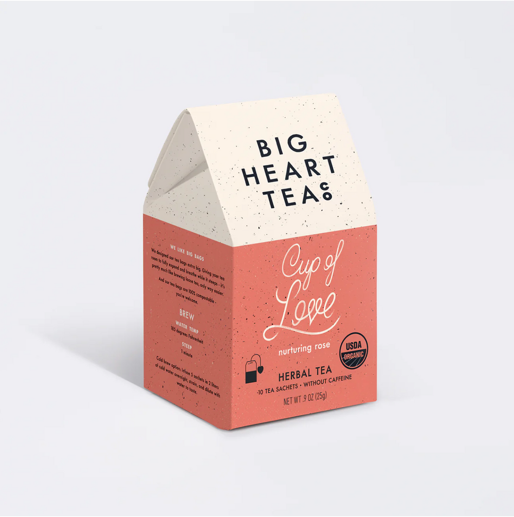 A Big Heart Tea Company Cup of Love bag of tea is angled to the right against a white background.