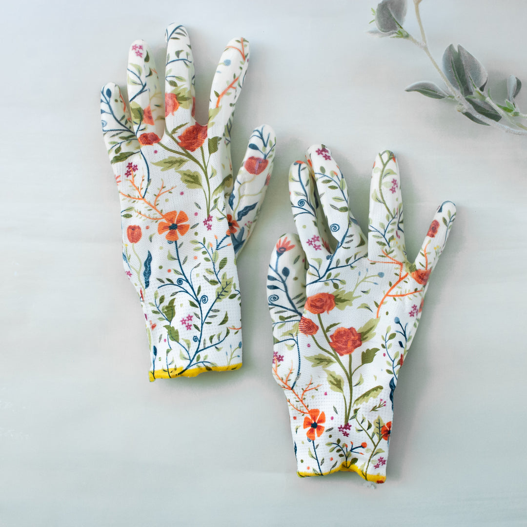 photo of two white gardening gloves with multi colored flowers displayed on the gloves