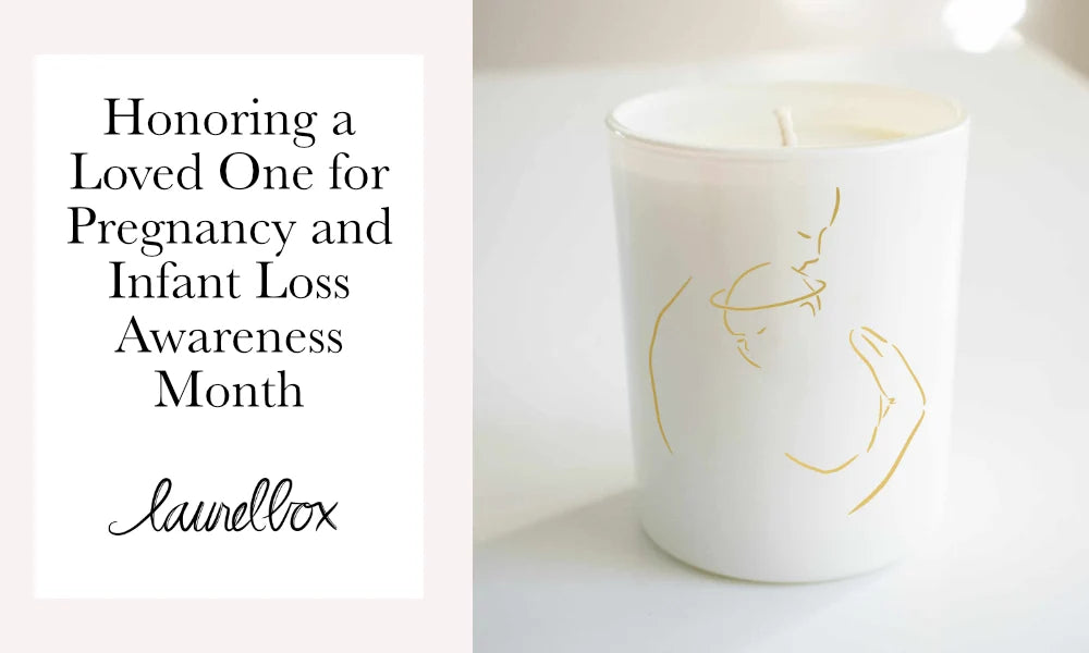 Candle with a white glass container featuring a gold line drawing of a parent holding a child centered on it. Honoring a Loved One for Pregnancy and Infant Loss Awareness Month.