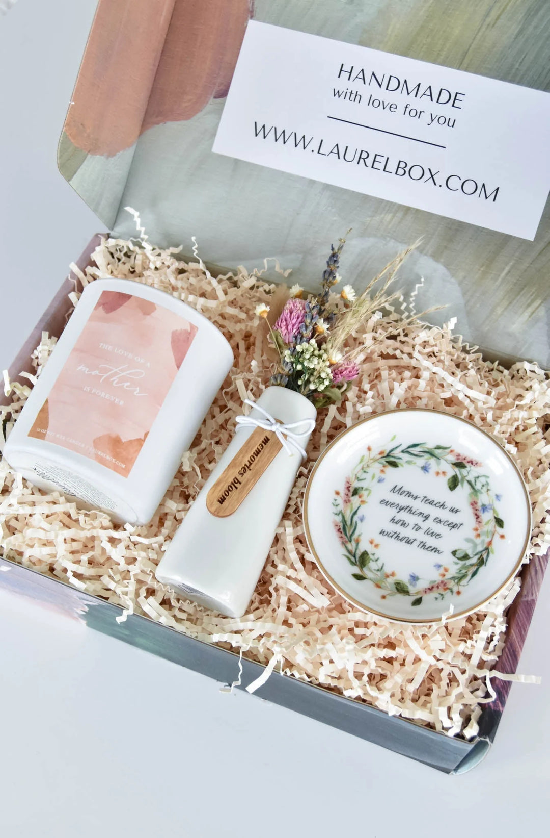 Sympathy gift box with a candle, a ceramic dish, and a bottle. Features floral designs and text. 25 Thoughtful Sympathy and Grief Gift Ideas for 2026.