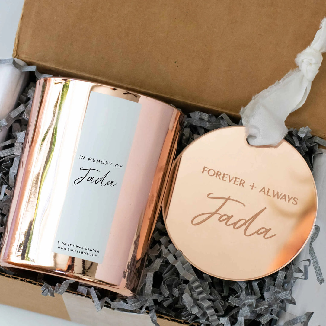 Rose gold soy wax candle with a label reading 'In Memory of Jada' and a round metal tag saying 'Forever + Always Jada'. Why Personalization Matters - How Custom Sympathy Gifts Can Make a Difference.