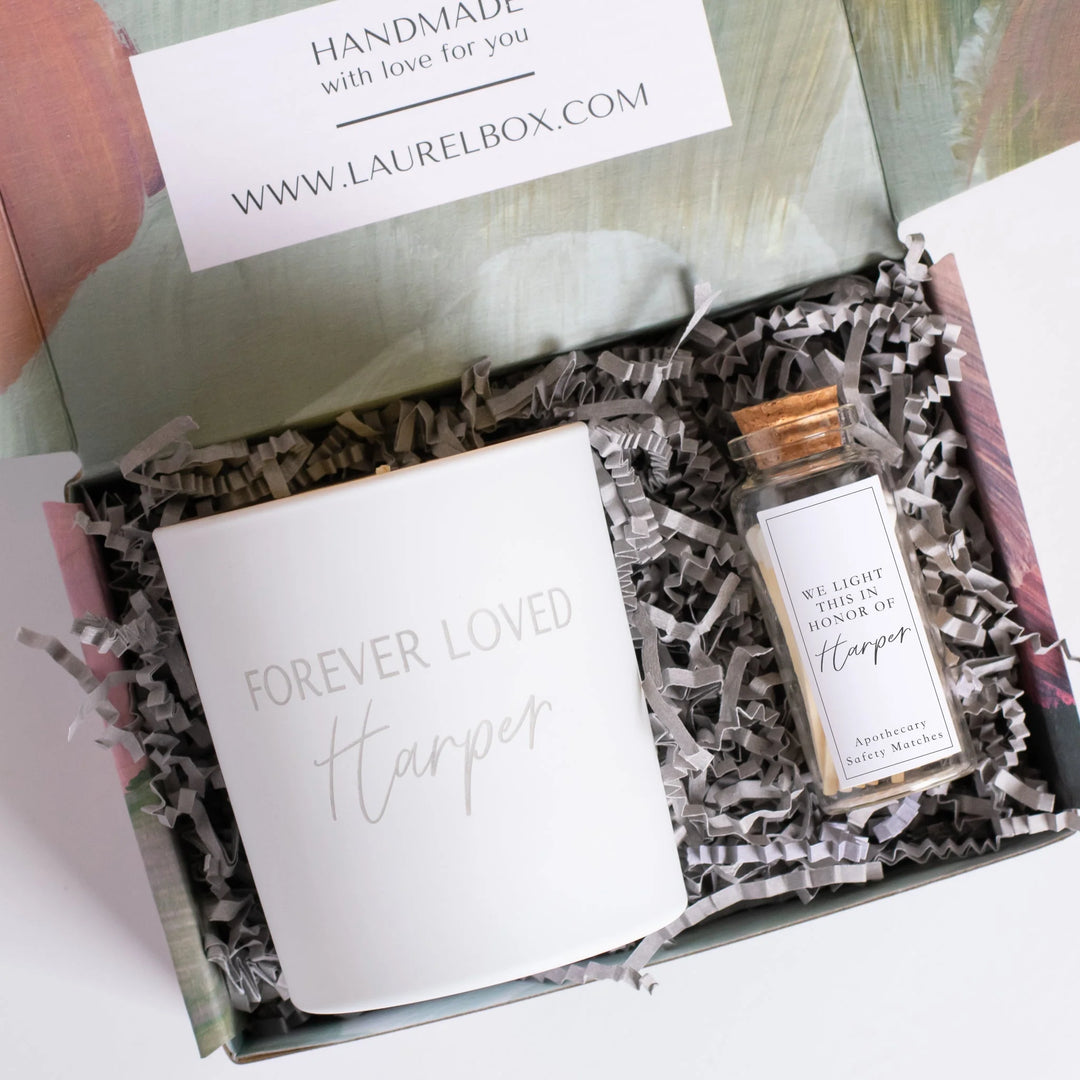 Customizing Sympathy: Personalized Gift Ideas for Every Stage of Grief, white candle with 'FOREVER LOVED Harper' text and match jar.