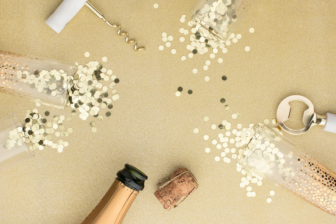 Starting the New Year with Hope: Sympathy Gift Ideas for Those Who Have Experienced Loss. Gold confetti, champagne bottle, cork, and opener.