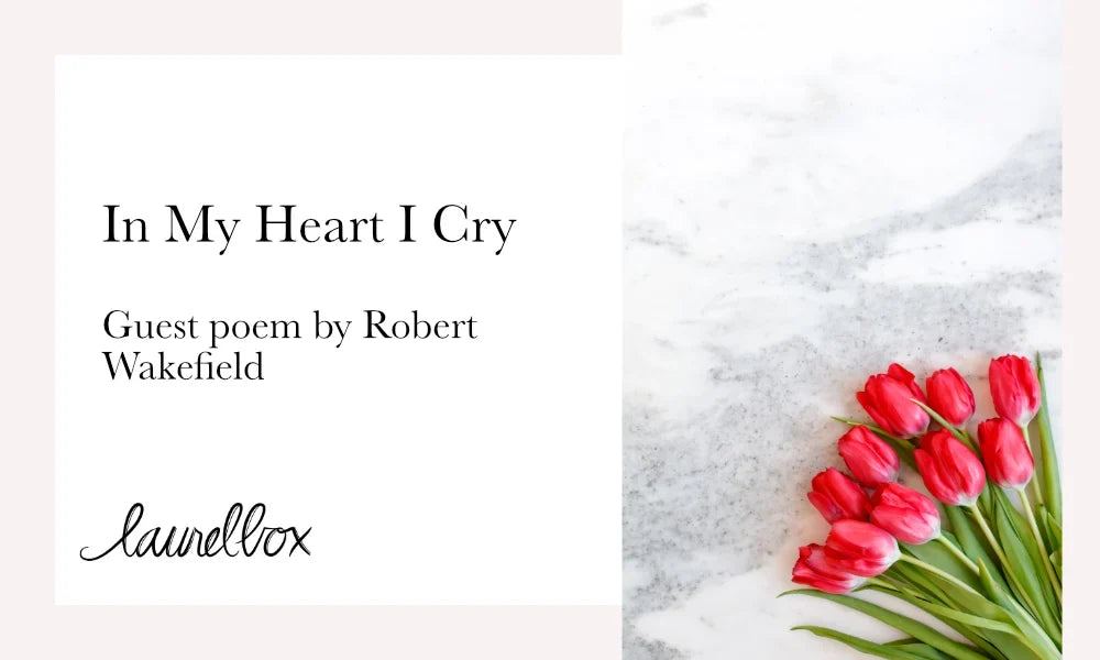 In My Heart I Cry poem by Robert Wakefield displayed with pink tulips on a marble background.