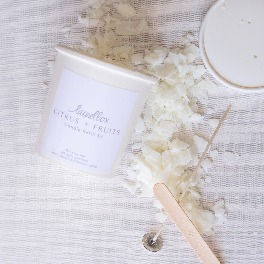 Citrus + Fruits candle refill kit in a white container with wax flakes, wooden stick, and metal wick holder. Relight Their Memory: Step-By-Step Guide To Refill A Custom Keepsake Candle.