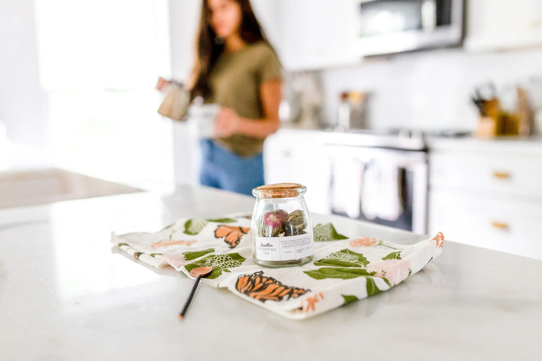 Wellness Through the Mourning Process: 10 Ways to Fight the Harmful Effects of Grief, jar with colorful contents on floral cloth.