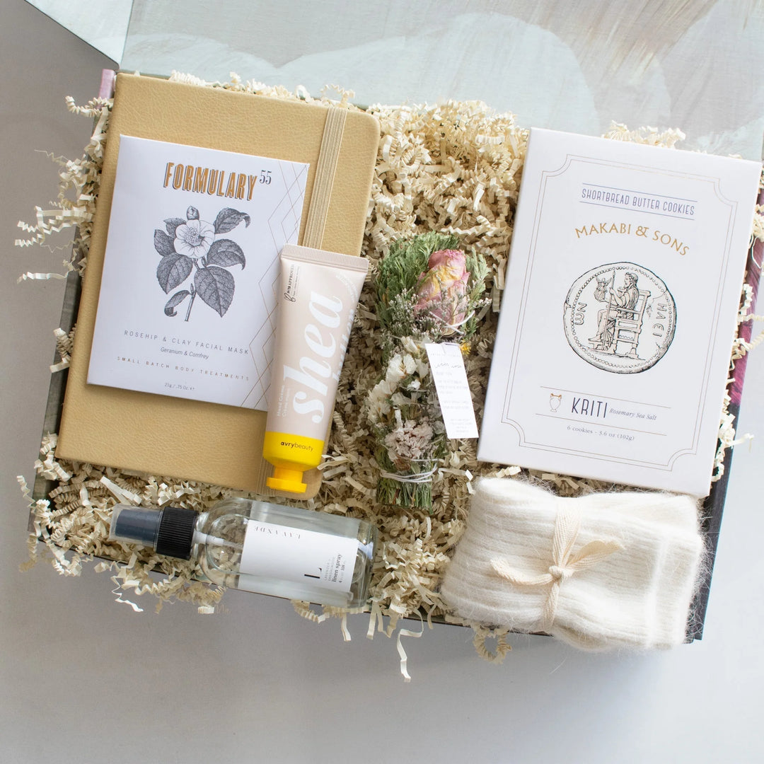 Best Gifts for a Friend Going Through IVF: A Complete Guide. A gift box containing a facial mask, shea cream, dried flowers, and cookies.