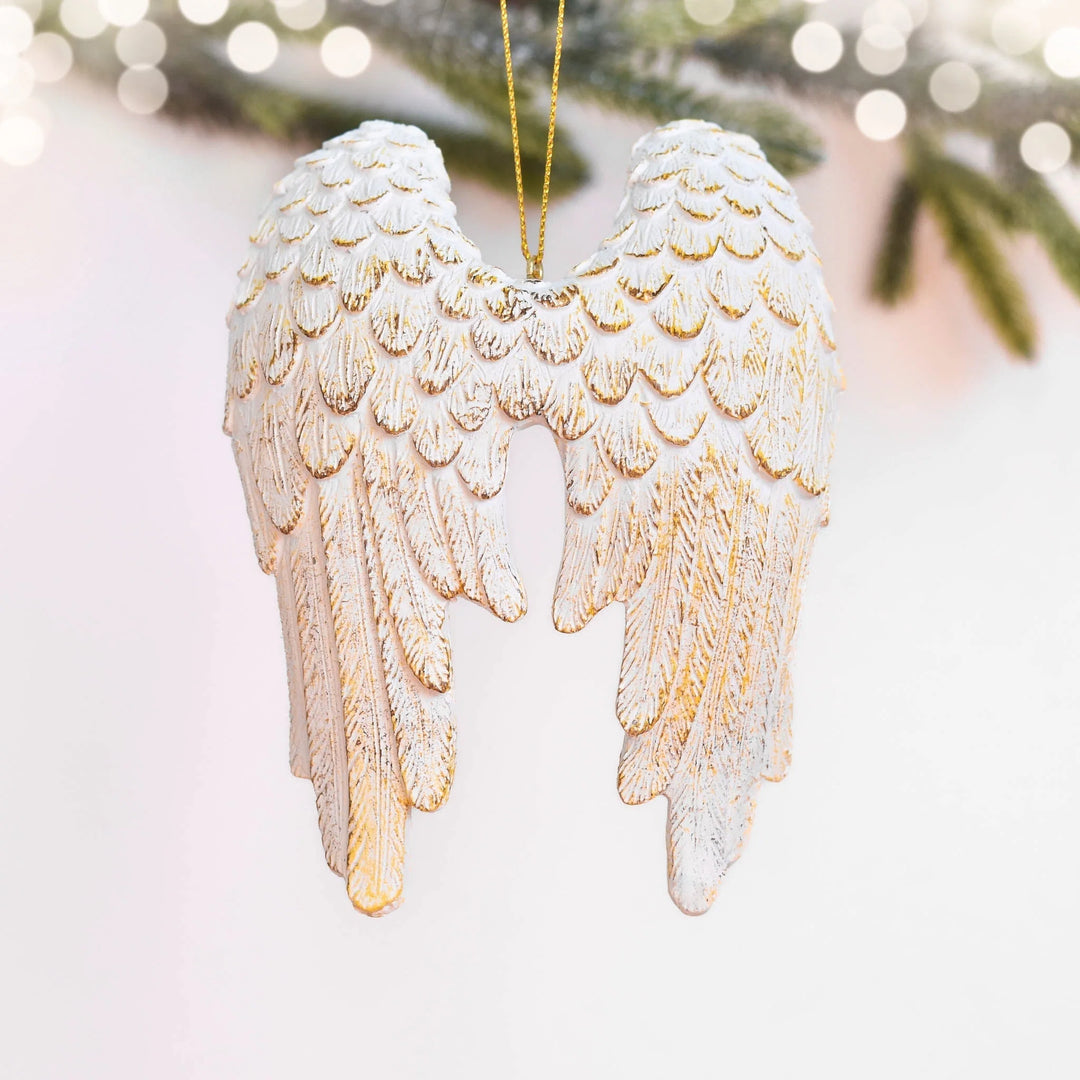 White angel wings ornament with gold detailing, showing intricate feather texture, for remembrance, 10 Ways to Cope with Your First Holiday Without a Loved One.
