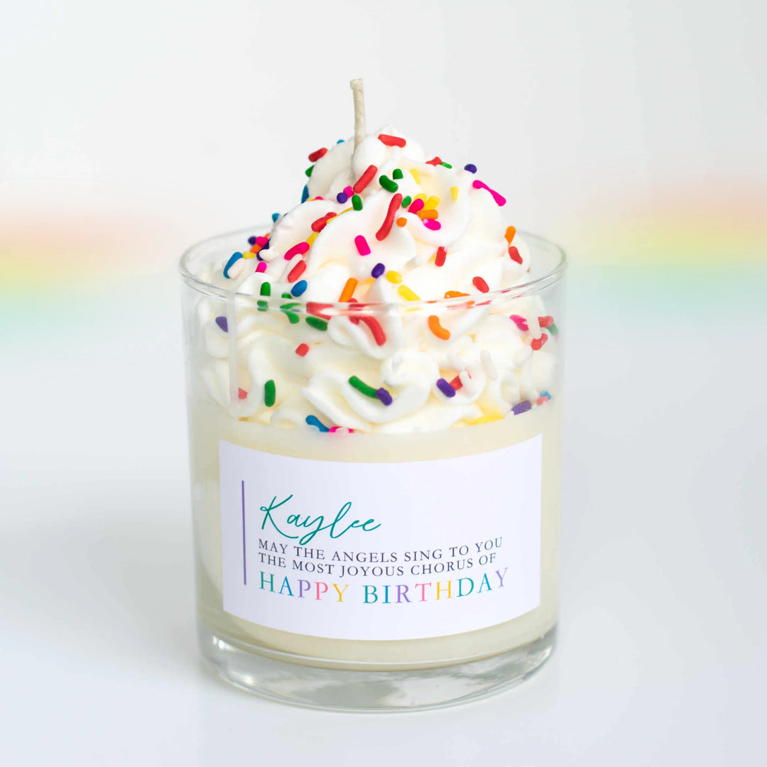 Candle in clear glass with whipped cream, colorful sprinkles, and a label reading "Happy Birthday" for 26 Meaningful Ways to Honor a Loved One’s Death Anniversary.