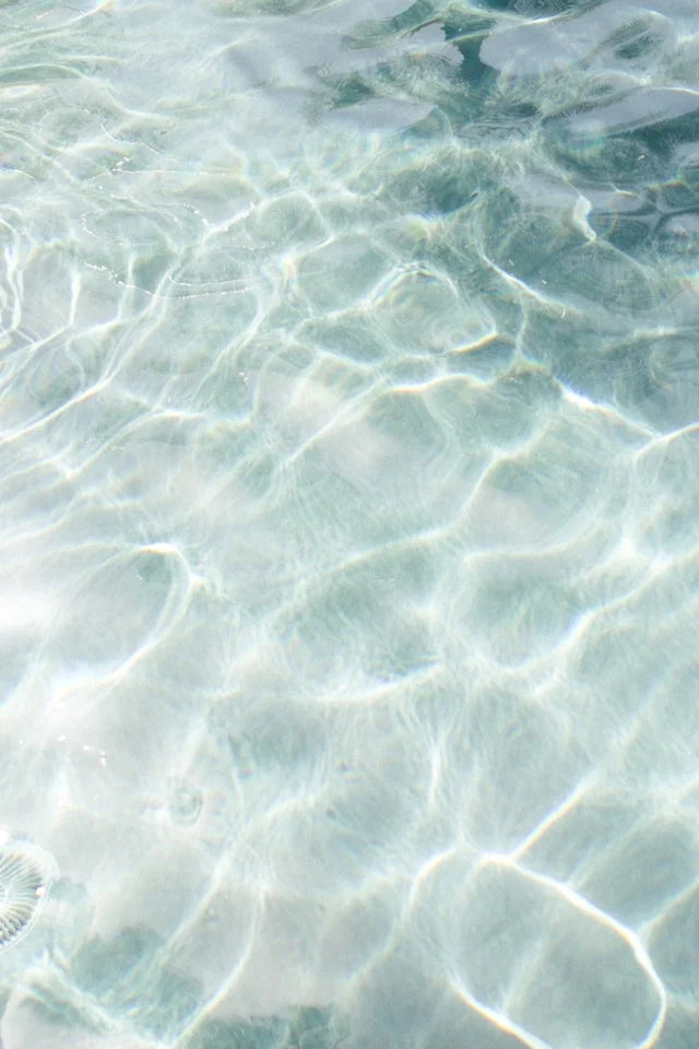 Clear water surface with gentle ripples, sunlight reflecting, representing tranquility in Unique Ways to Memorialize Loved Ones in Summer.