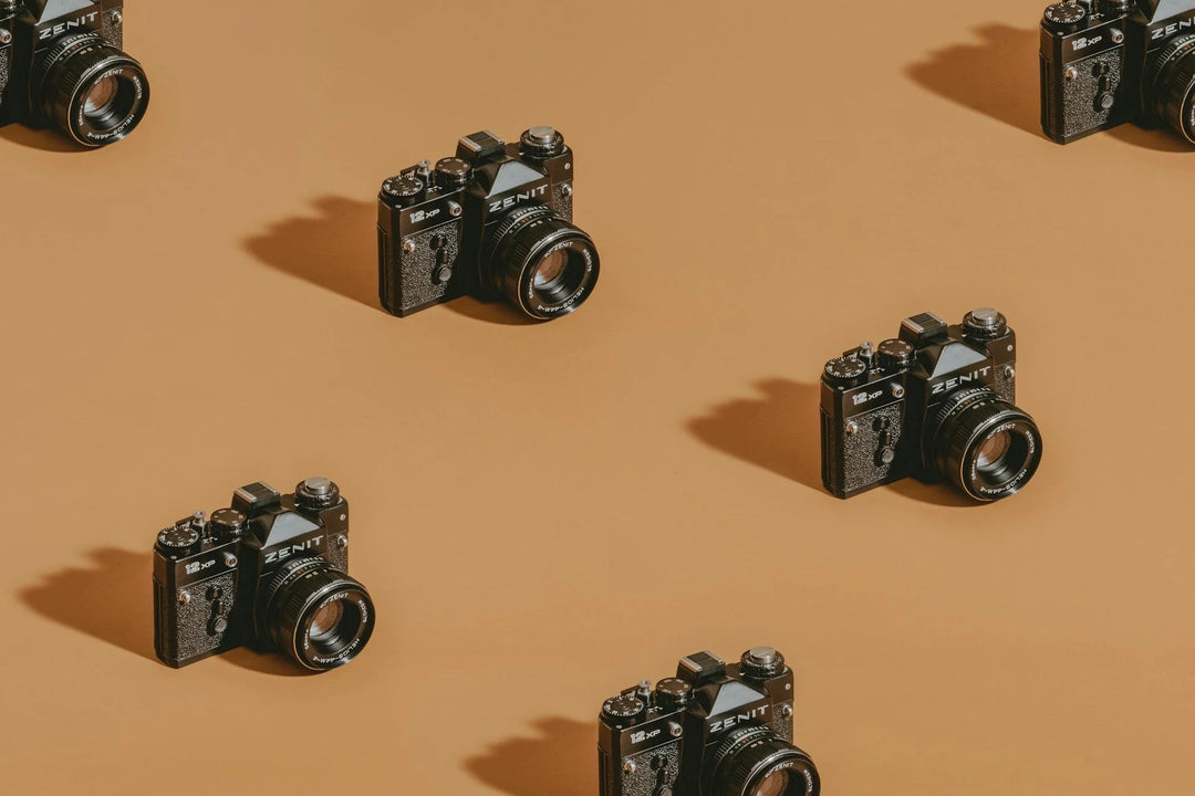 Zenit camera in black, positioned on a brown background, showing lens and dials, emphasizing The Importance of Taking Photos & Videos of Life’s Everyday Moments.