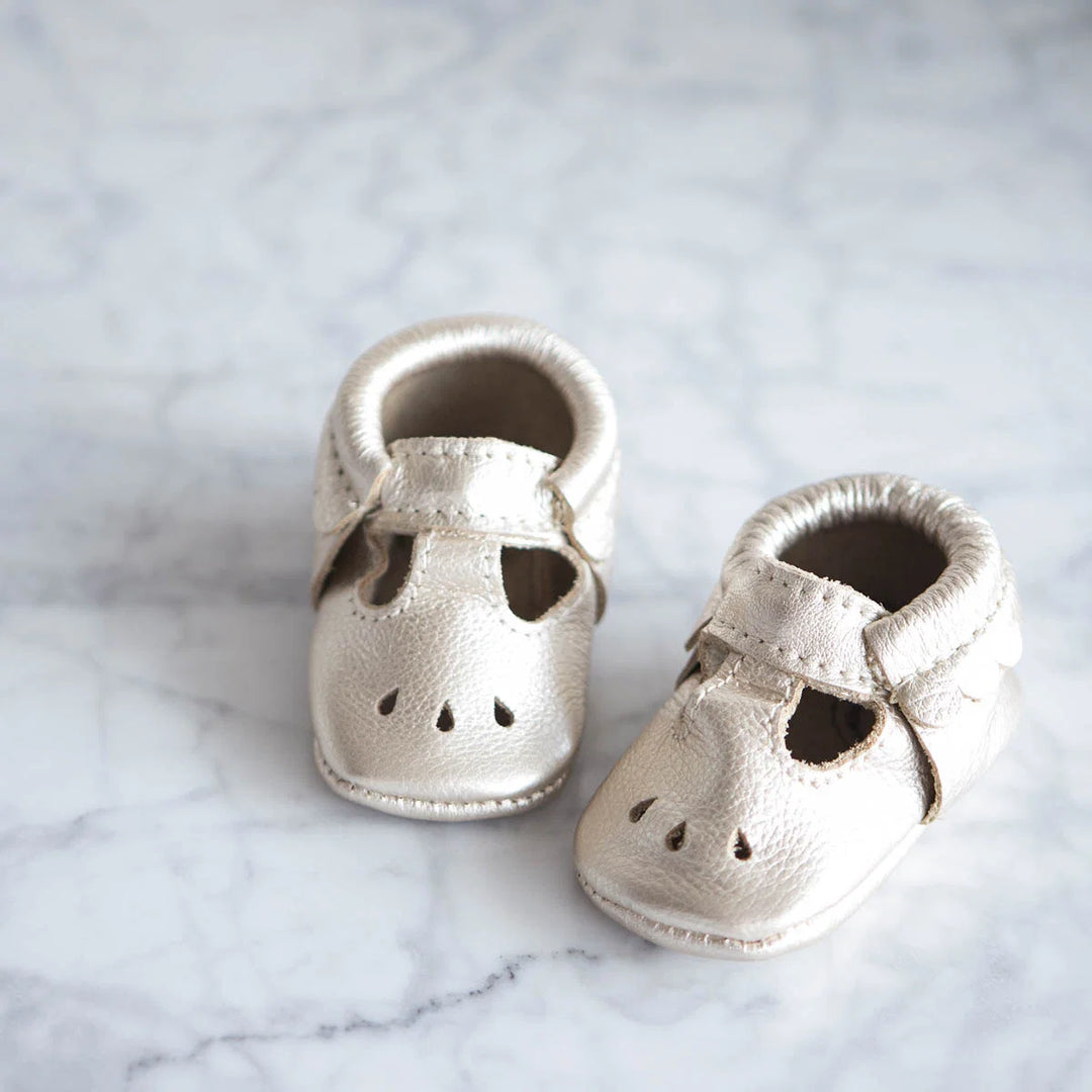 All I Want For Christmas Is a Baby (and other wish lists that Amazon can’t fulfill…). Gold baby shoes with perforated design and strap.