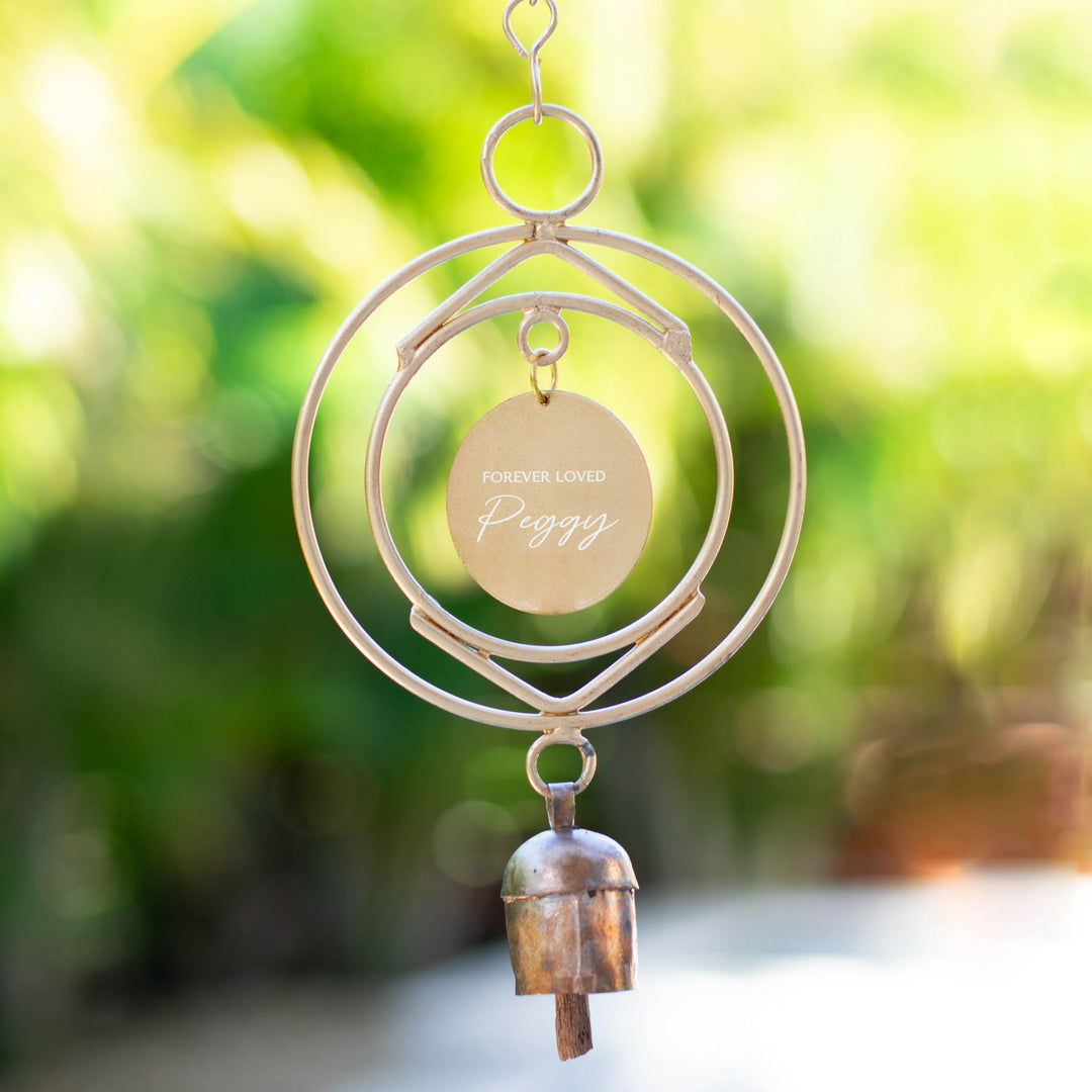 Custom Remembrance Wind Chime with engraved tag reading 'Forever Loved Peggy', metal design with bell at the bottom.