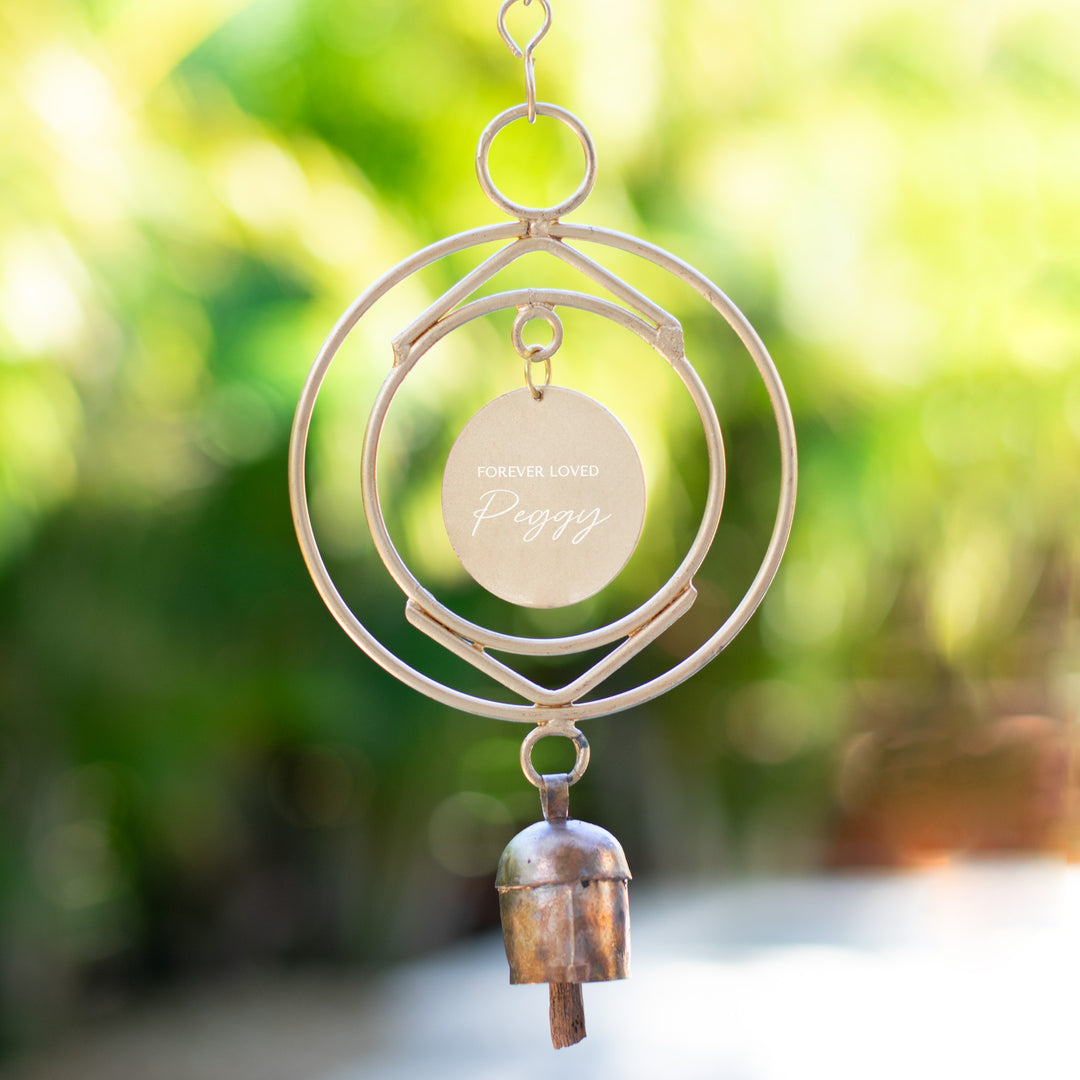 Custom Remembrance Wind Chime with engraved tag reading 'Forever Loved Peggy', metal design with bell at the bottom.