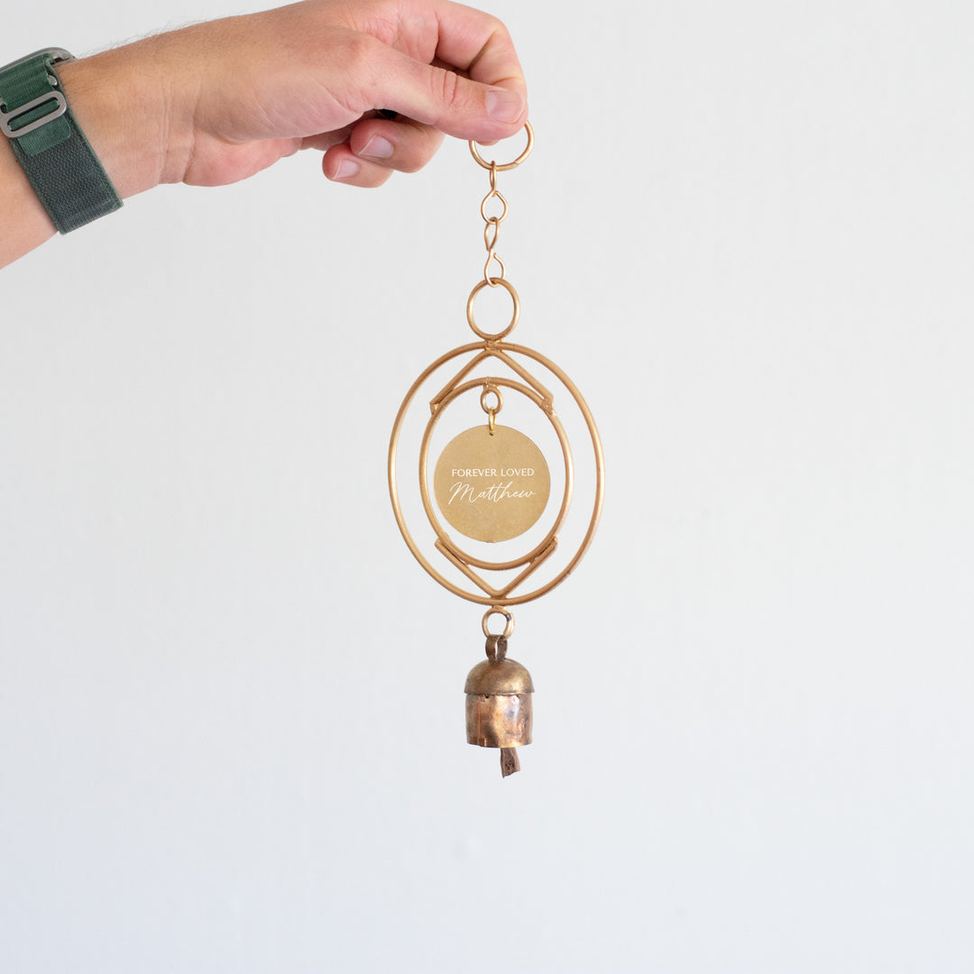 Custom Remembrance Wind Chime in gold with engraved tag reading &