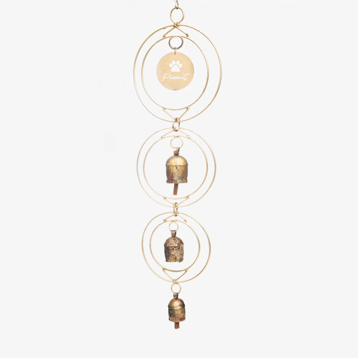 Dog Loss Wind Chime with three bronze bells, gold circles, and a brass name tag engraved with a paw print and name.