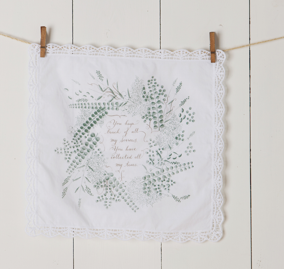 Collecting Your Tears Handkerchief with floral design, lace edges, white cotton fabric, and printed text in green and brown.