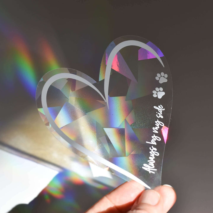 Always by My Side Pet Memorial Rainbow Decal, clear prismatic heart with the text and paw prints, catching sunlight.