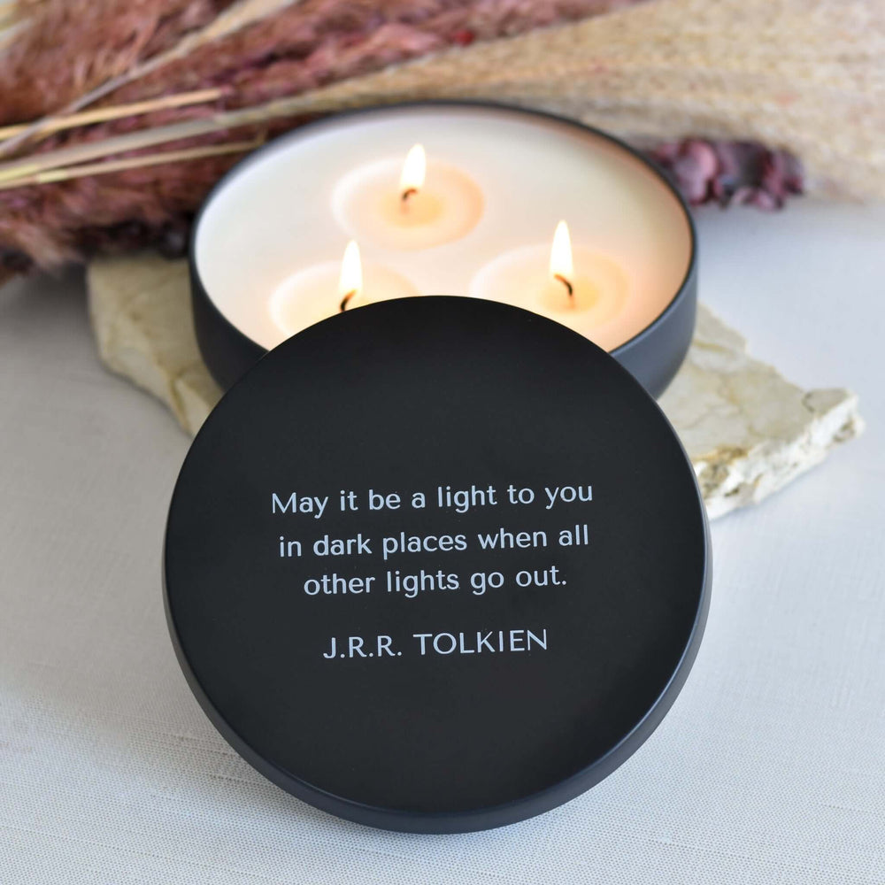 Morningside Employee Sympathy Gift, black candle lid with quote, wax candles burning in white container, stones in background