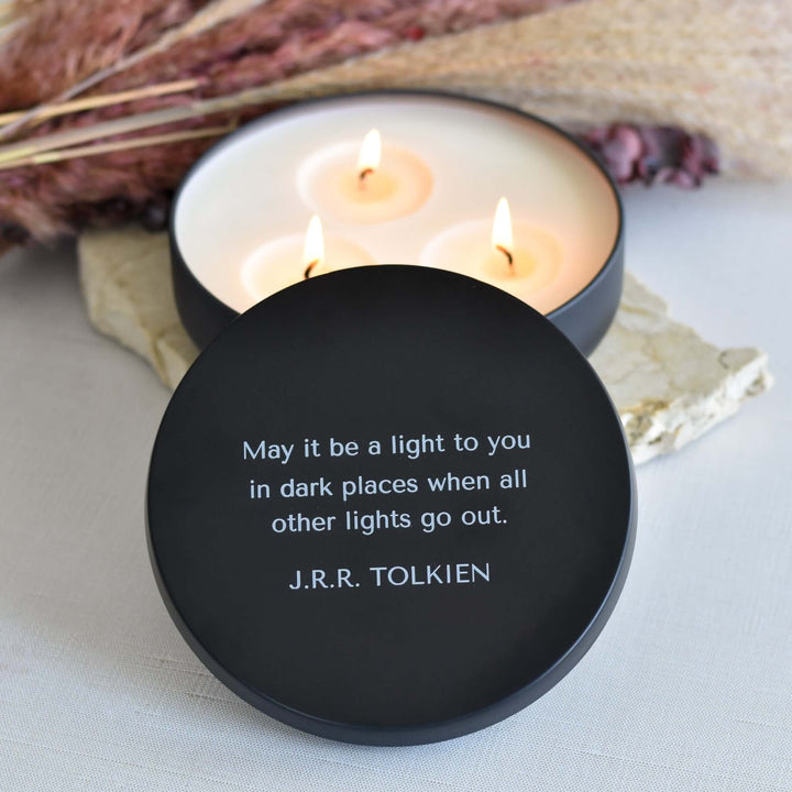 Morningside Employee Sympathy Gift, black candle lid with quote, wax candles burning in white container, stones in background