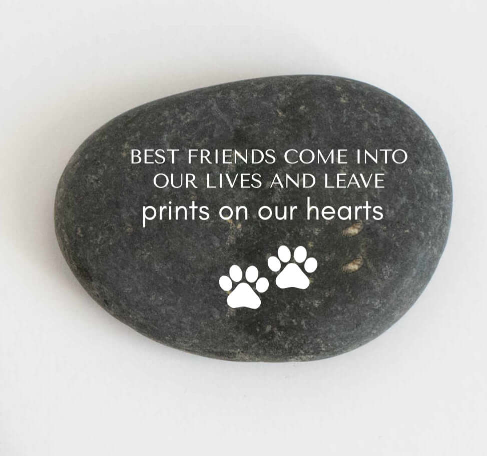 Flat black stone with white engraved text and paw prints, symbolizing a pet memorial. Pet Memorial Garden Set.
