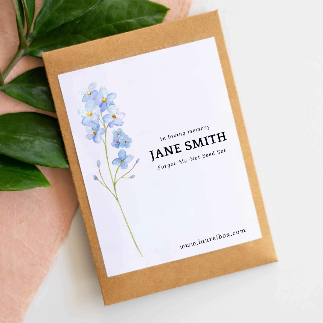 Custom Forget-Me-Not Garden Seed set in a kraft envelope with blue flower illustration and printed text.