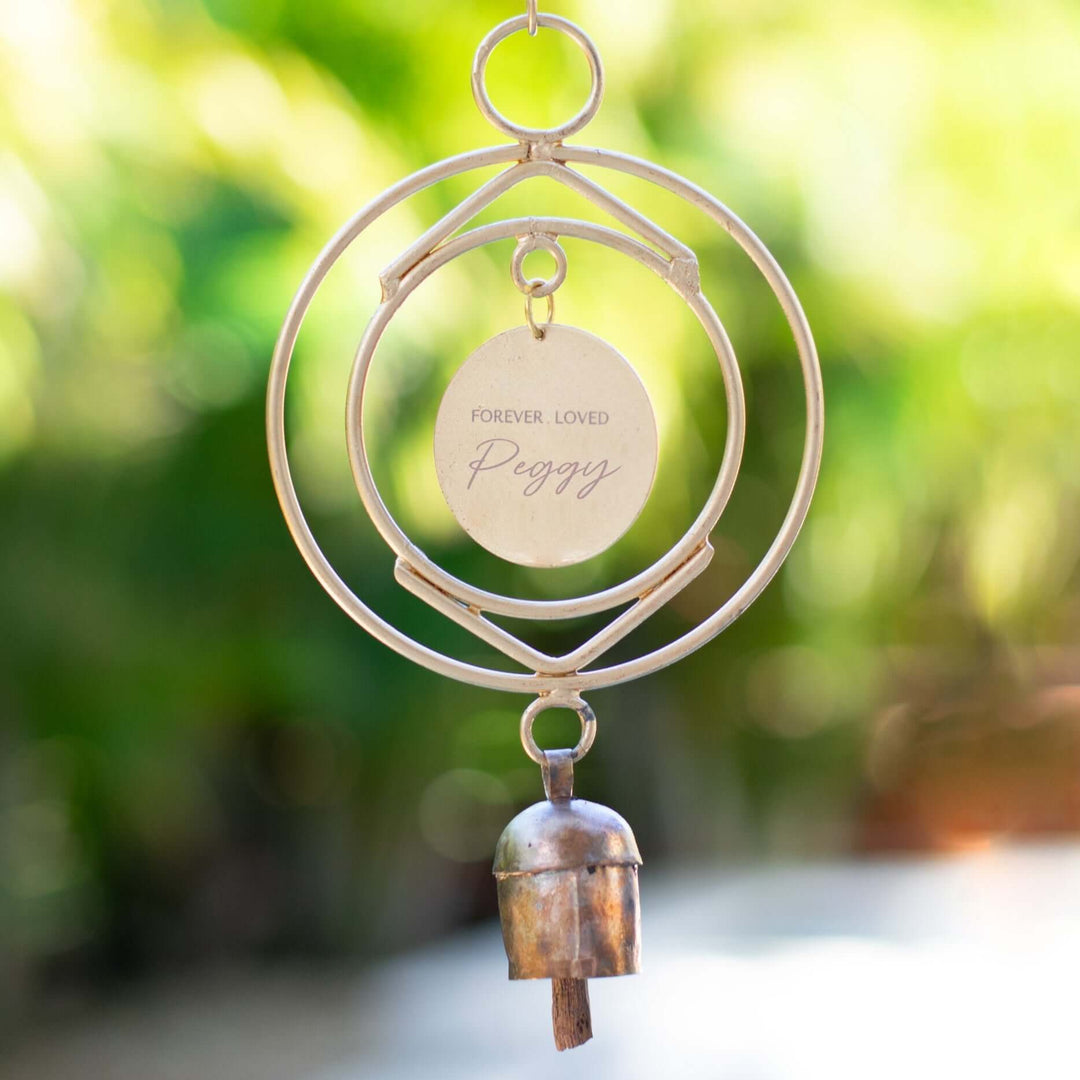 Custom Remembrance Wind Chime with engraved disc saying 'FOREVER LOVED Peggy' and copper bell, made of metal.
