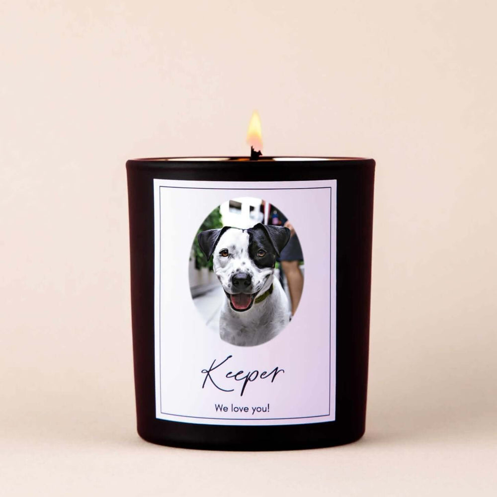 Custom Memorial Pet Photograph Candle with a black container, featuring a dog's photo and text: 'Keeper' and 'We love you!'. Symmetrical design.