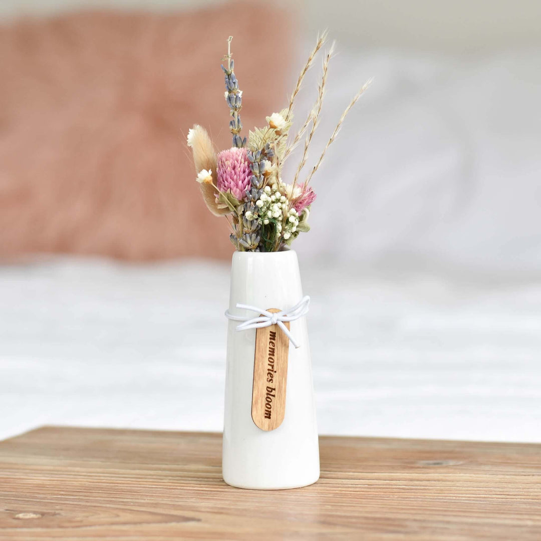Memories Bloom Forever Dried Floral Bouquet in a white vase, featuring dried flowers and a maple tag with engraved text.