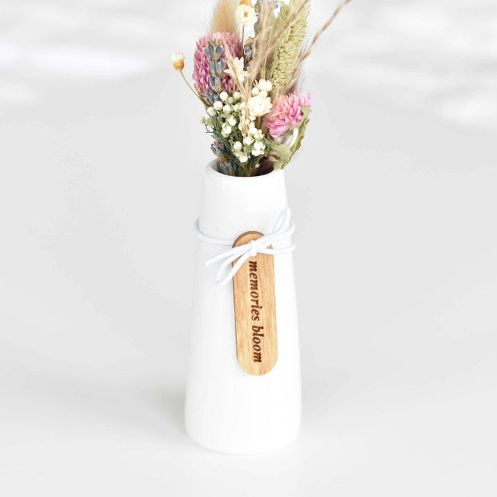 Memories Bloom Forever Dried Floral Bouquet in a white ceramic vase with dried flowers and a wooden tag engraved &