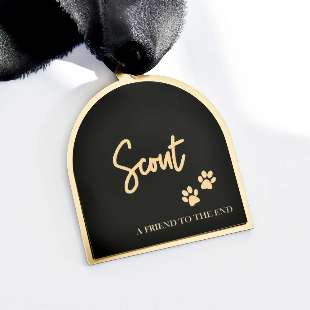 Friend to the End Pet Memorial Ornament in black and gold acrylic with engraved name "Scout" and paw prints