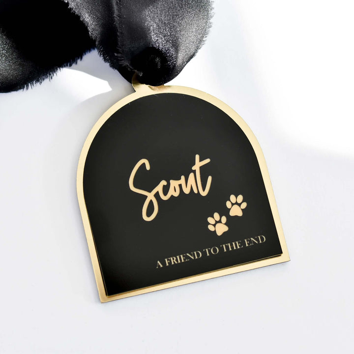Friend to the End Pet Memorial Ornament in black and gold acrylic with engraved name "Scout" and paw prints