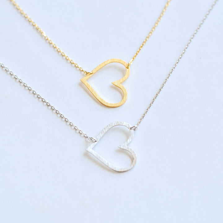 Heart to Heart Necklace in gold and silver, featuring open heart pendants on delicate chains.