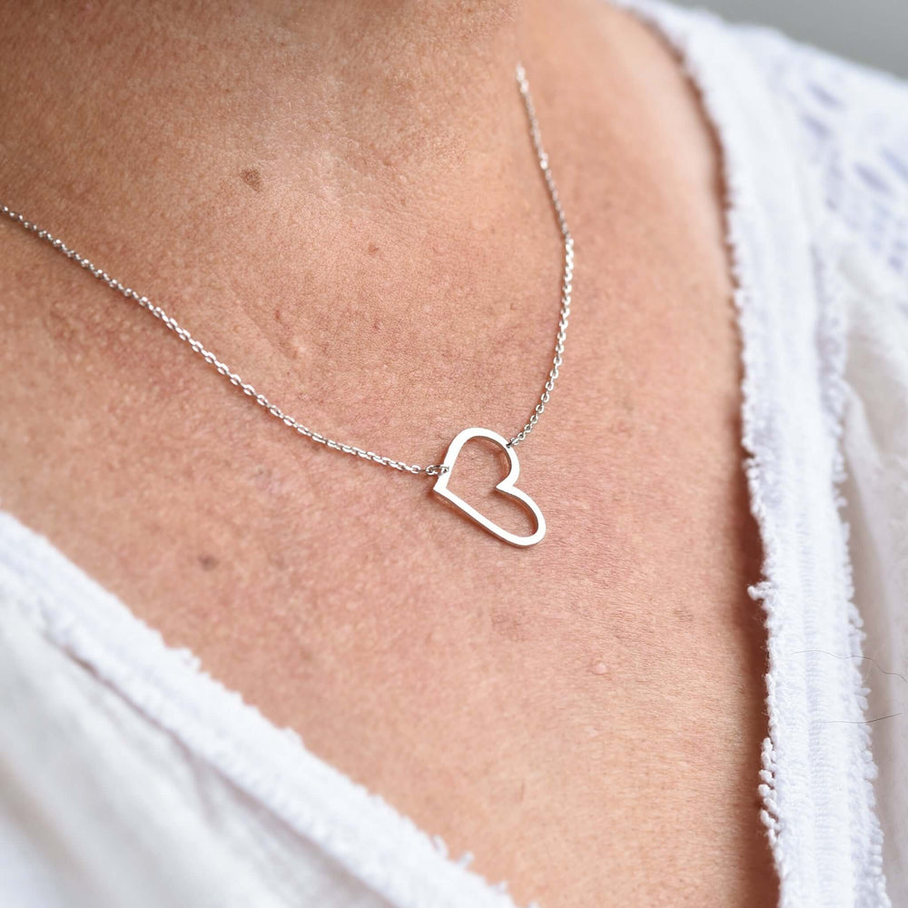 Heart to Heart Necklace in sterling silver, featuring an open heart design on a delicate chain worn around the neck.