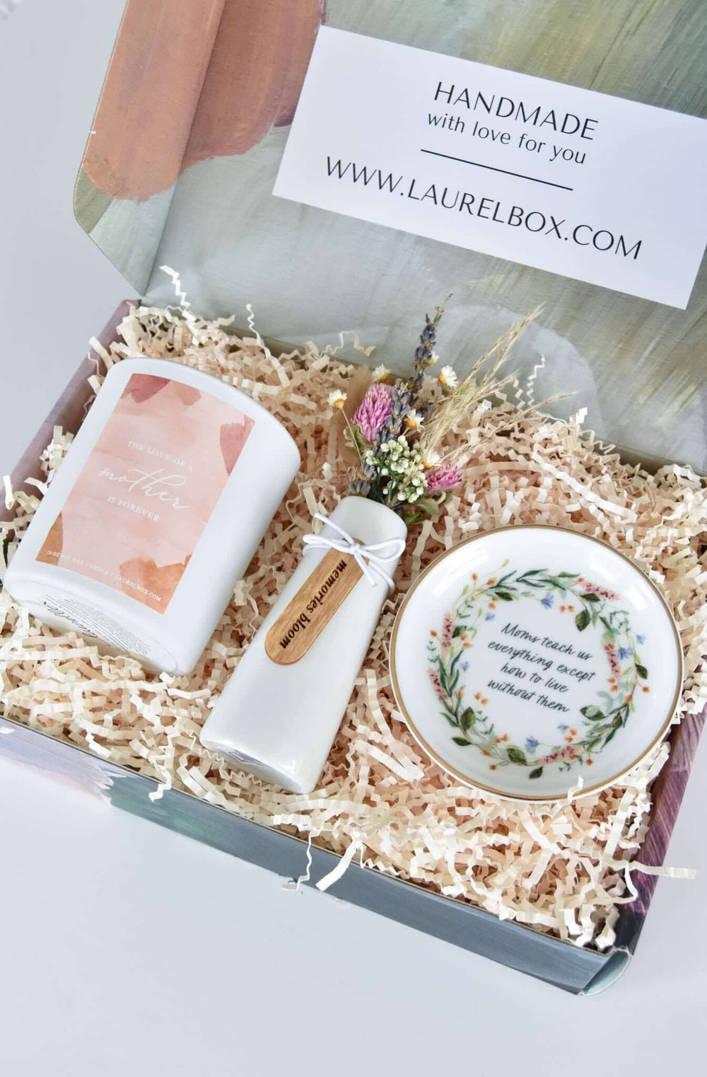 In Memory of Mom Gift Box with candle, vase, and dish in shredded paper, features floral designs and a heartfelt message.