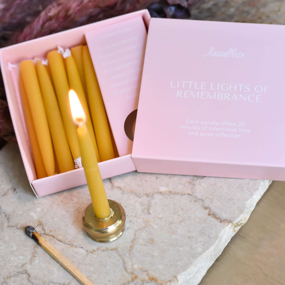 Little Lights of Remembrance set with yellow candles in pink box, classic candle holder, and a matchstick.