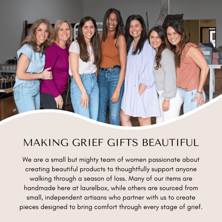 Group of women standing together in casual attire, smiling, indoors, promoting grief gift products.