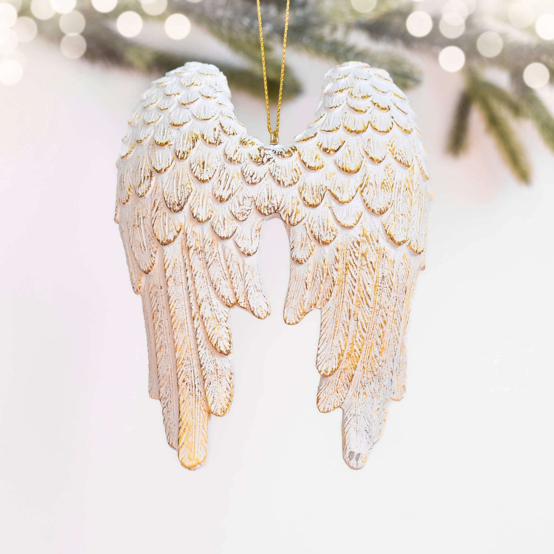 Memorial Angel Wing Ornament in white resin with gold detailing, shaped like angel wings, hung with a gold string.