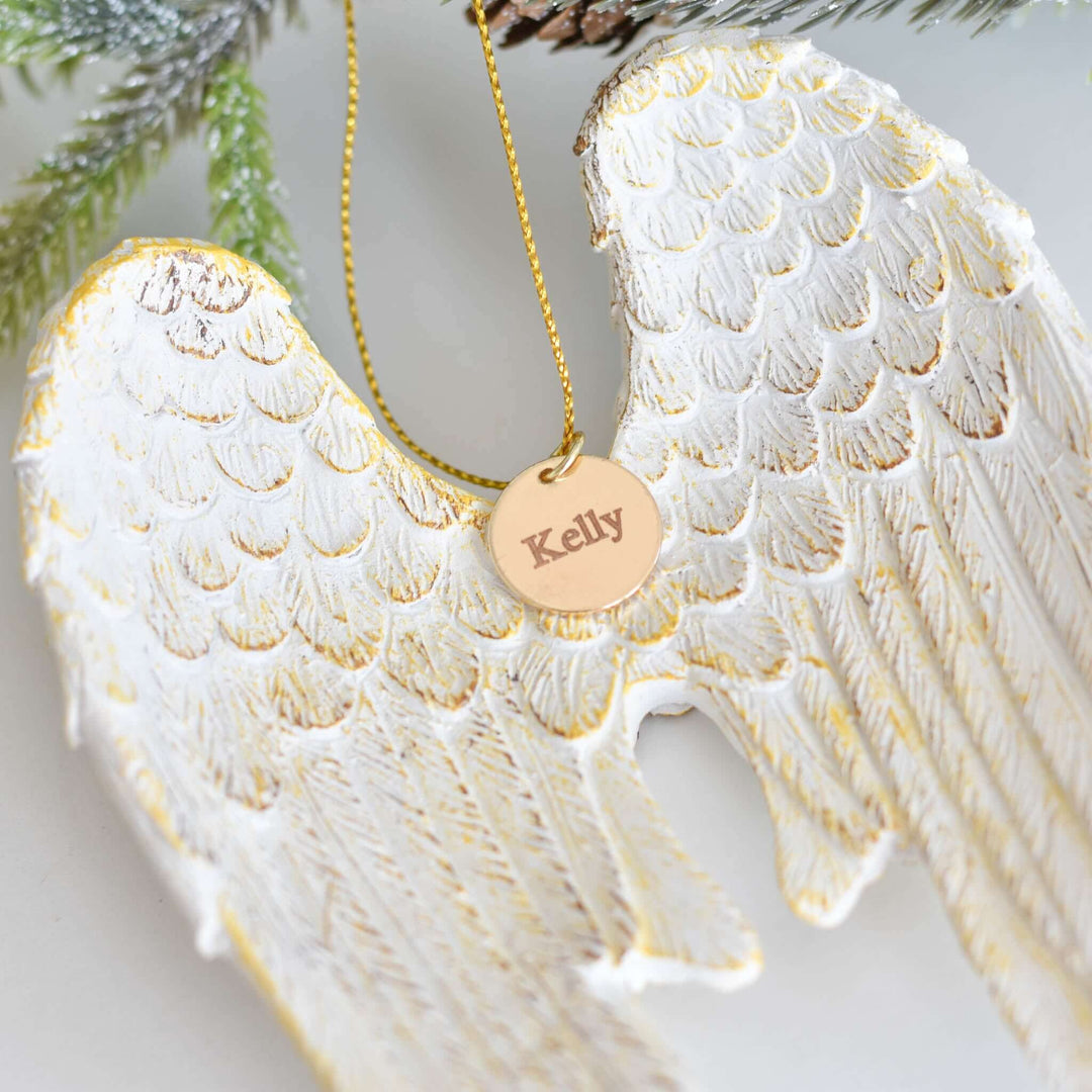 Memorial Angel Wing Ornament in white resin with gold detailing, hanging tag engraved with &