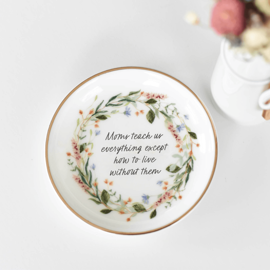 A Mom's Love Jewelry Dish, 4" porcelain dish with floral design and quote, circular shape, gold rim.