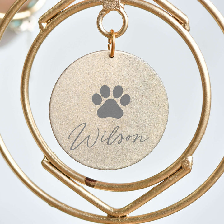 Personalized Dog Loss Wind Chime with a gold circular tag showing a paw print and the name "Wilson" engraved.