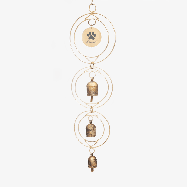 Dog Loss Wind Chime with three metal bells hanging from gold rings, featuring a tag engraved with the name "Peanut" and a paw print.