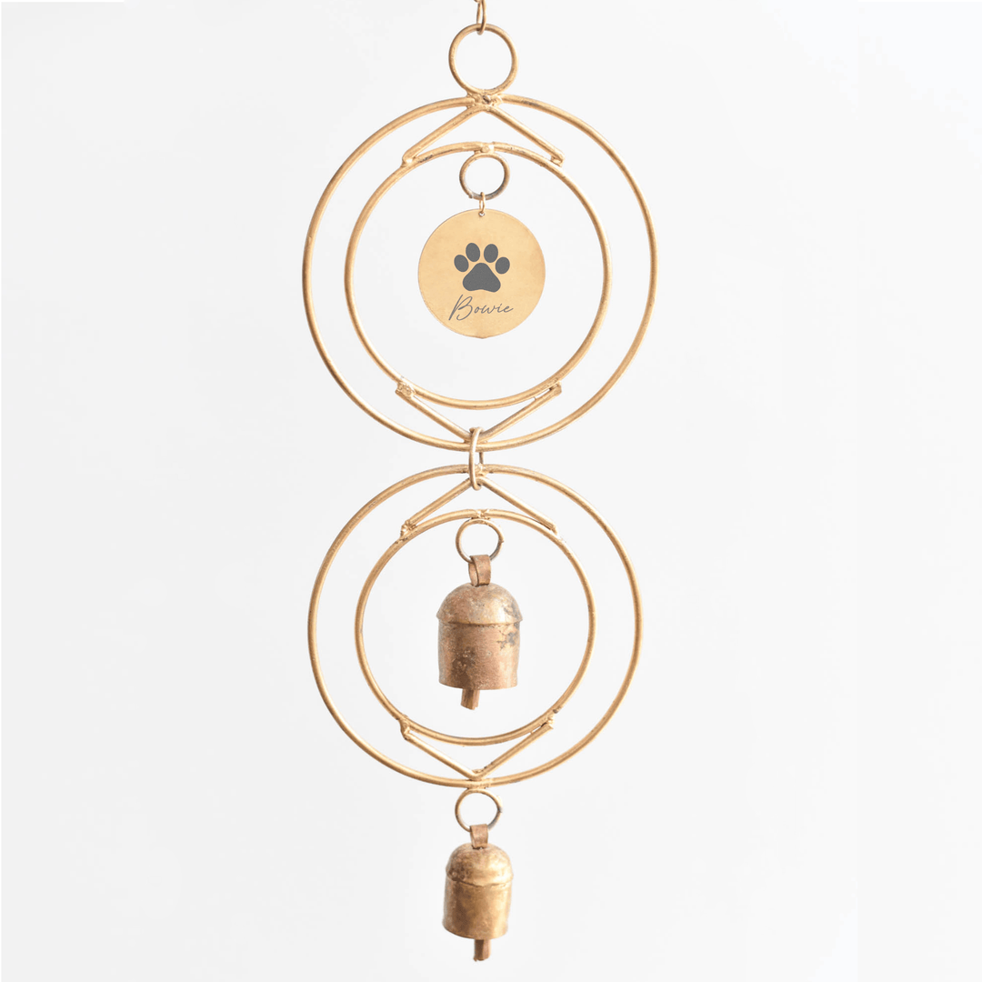 Personalized Dog Loss Wind Chime with custom engraved name tag and two handcrafted bronze bells, hanging on a gold frame.