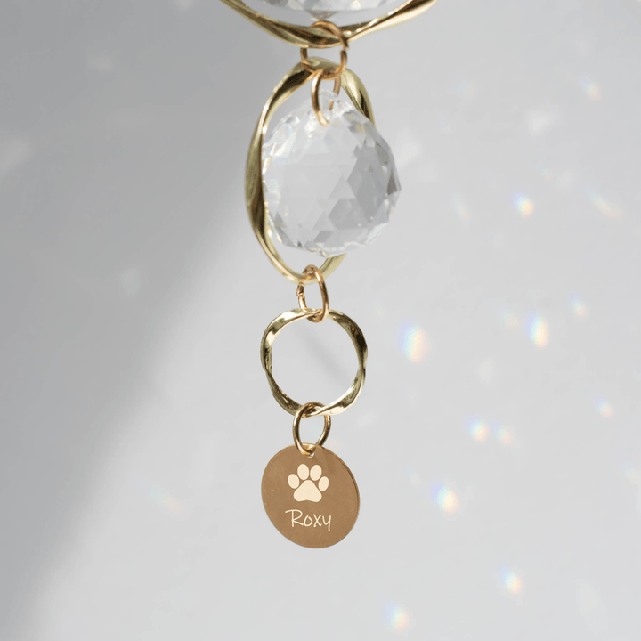 Pet Memorial Sun Catcher and Rainbow Maker with a crystal charm, gold rings, and engraved tag reading &