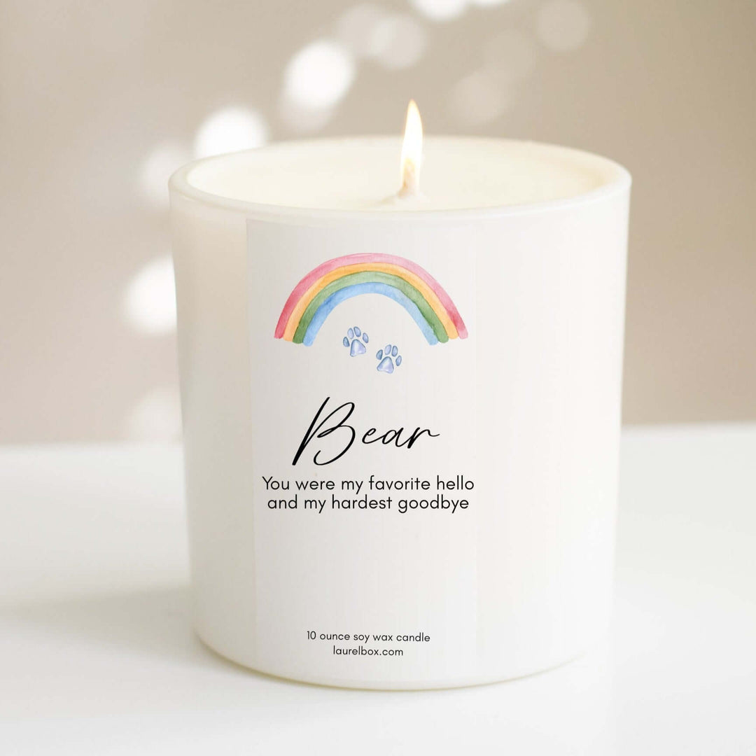 Rainbow Bridge Pet Loss Memorial Candle in white, with rainbow and paw print design, personalized with the name 'Bear'.