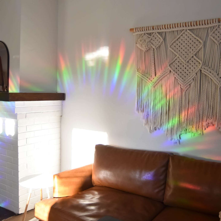 Look for me in Rainbows Sun Catcher Decal Set casting colorful rainbows on a wall near a macrame wall hanging.