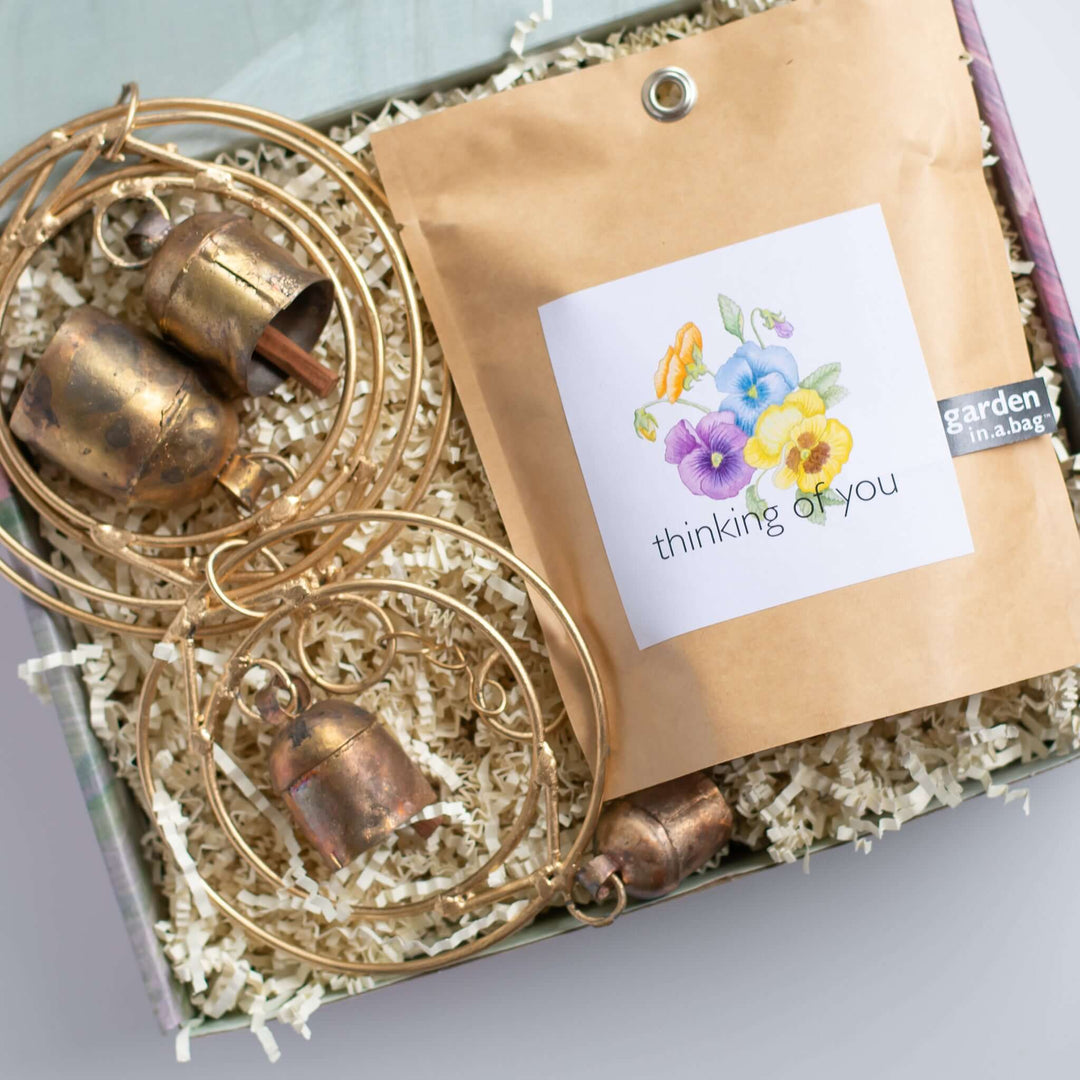 Morningside Resident Sympathy Gift in a gift box, including golden bells and a brown packet with flowers and &